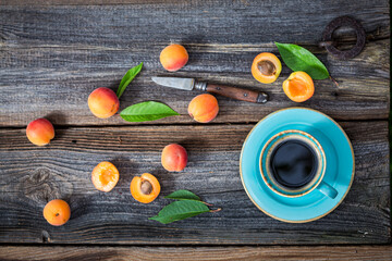 Naklejka na ściany i meble Hot coffee and plums in sunny garden