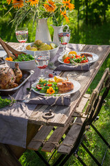 Homemade dinner with salad served in garden. Dinner in garden.