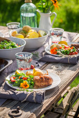Homemade dinner with chicken served in garden. Chicken for dinner.