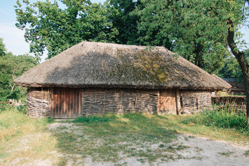 Fototapeta na wymiar old rural house with thatched roof