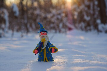 Figure of a wizard in the winter forest. A fairy-tale character.