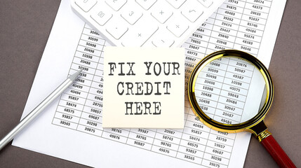 FIX YOUR CREDIT HERE text on sticker on chart ,with calculator and magnifier