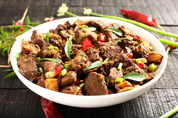 Bowl of tasty crispy fried mutton meat, Indian cooking .