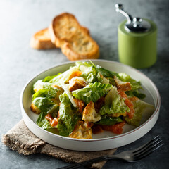 Traditional homemade Caesar salad with salmon