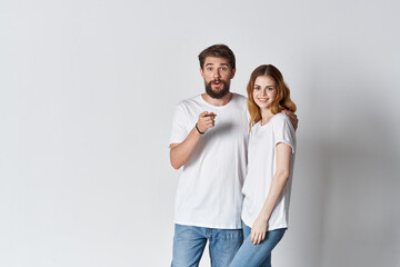 cheerful men and women are standing side by side in white t-shirts fashion design studio