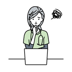 デスクで座ってPCを開いて困っている看護師の女性