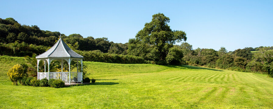 South Devon, England, UK. 2021.  Garden gazebo with surrounding shrubs in English rural countryside