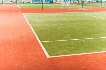 An empty tennis court ready to compete. Tennis court with artificial turf.