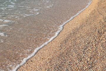 Beautiful seascape with waves and sea foam on shore