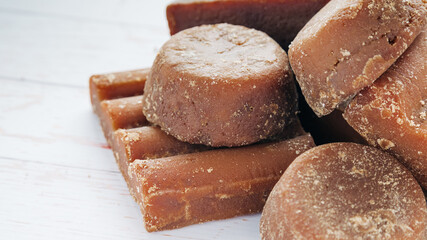 panela, from sugar cane, for different preparations on a white wooden base, made in Colombia.