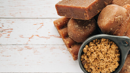 panela, from sugar cane, for different preparations on a white wooden base, made in Colombia.