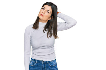 Beautiful brunette woman wearing casual clothes confuse and wondering about question. uncertain...
