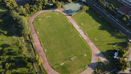 Aerial shot of empty soccer field in club front to river. © Santiago