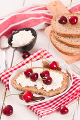Rye bread with cottage cheese and cherries.