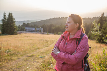 Woman enjoy nature view at sunset.Mountain landscape in background