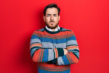Handsome caucasian man with beard wearing elegant wool winter sweater skeptic and nervous, disapproving expression on face with crossed arms. negative person.