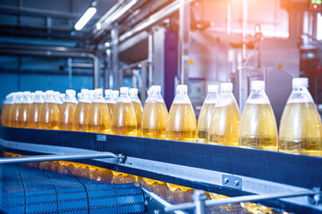 Conveyor belt with bottles for juice or water at a modern beverage plant