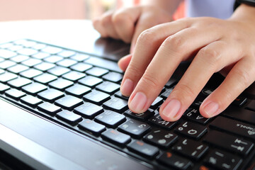 Woman hands typing on laptop, close-up, online education concept