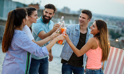 Group of happy friends having fun at rooftop party.