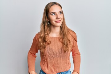 Fototapeta premium Young blonde woman wearing casual clothes looking to side, relax profile pose with natural face and confident smile.
