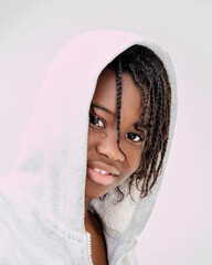 Pretty girl (thirteen years old) with cornrows wearing a hooded sweatshirt