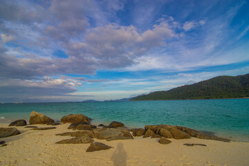 Tropical white sand beach o n island with mountain sea view