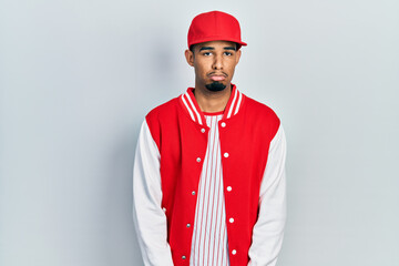 Young african american man wearing baseball uniform depressed and worry for distress, crying angry and afraid. sad expression.