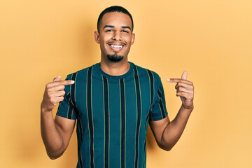 Young african american man wearing casual clothes looking confident with smile on face, pointing oneself with fingers proud and happy.