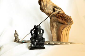 Fototapeta na wymiar Lord Ganesha stone statuette on a white background