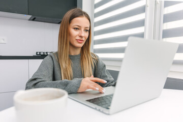 Girl working on laptop at the table