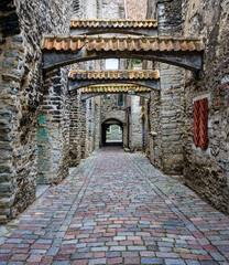 Narrow medieval alley with tile arches in the Estonian city of Tallinn.