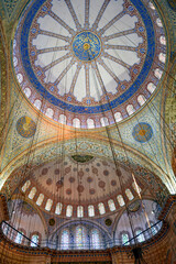 Fototapeta na wymiar Ceiling and interior of the famous Blue Mosque in Istanbul with its ancient and colorful mosaics