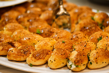 Closeup of fresh baked buns on tray. Stuffed buns served for breakfast on buffet line