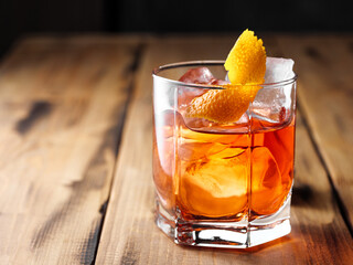Negroni cocktail on a wooden table. Copy space.
