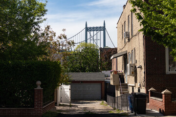 Triborough Bridge seen from a Residential Alley with Old Homes in Astoria Queens New York