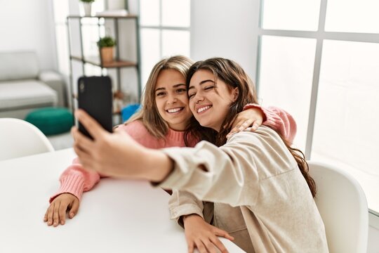 Young couple smiling happy making selfie by the smartphone at home.