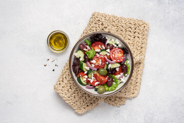 Greek salad with feta cheese and fresh vegetables on white background