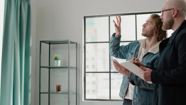 Apartment owner with curly hair explains designer flat style