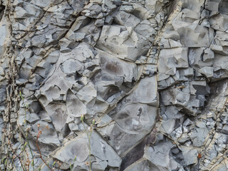 Old texture of mountain stones close up. Stone gray volumetric background. Geology. Pattern. Horizontally