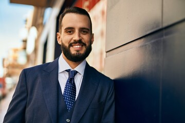 Fototapeta premium Young businessman smiling happy standing at the city.