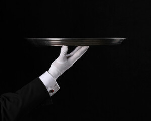 hand of a waiter with a tray on a black background