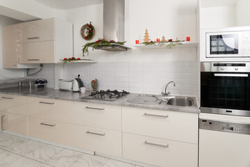 Bright modern kitchen decorated for Christmas. Concept of interior spacious kitchen.