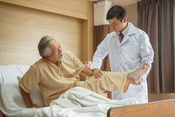 doctor examining the knee and leg  after surgery of asian senior old man patient suffering from...