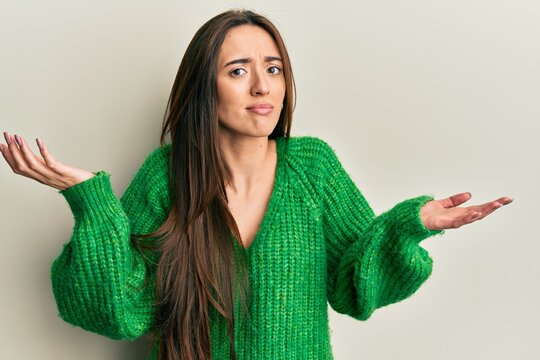 Young hispanic girl wearing casual clothes clueless and confused with open arms, no idea and doubtful face.