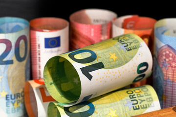 Rolled-up and laid-up euro banknotes