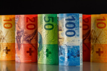 Rolled-up Swiss banknotes