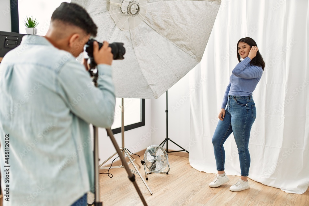 Sticker beautiful model posing for professional photographer man at photography studio.