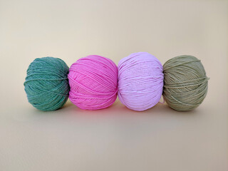 Colorful balls of wool on yellow background