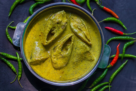 Sorshe Illish or Hilsa fish cooking with mustard seed.famous Bengali food.