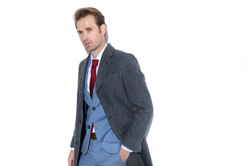 handsome businessman posing with one hand in pocket